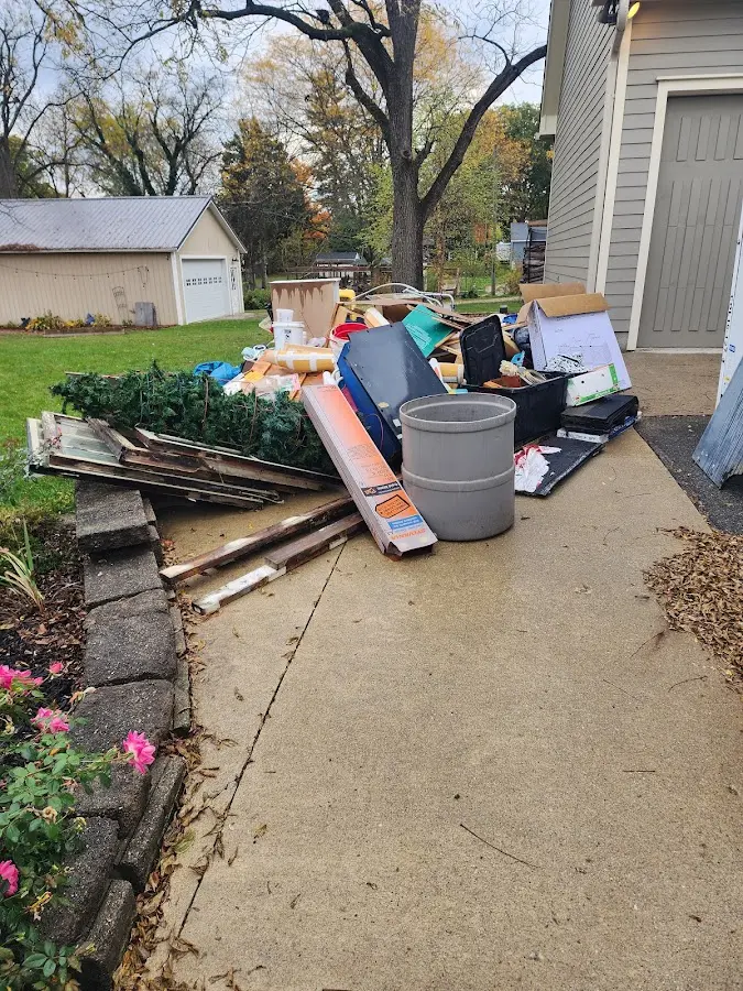 Dumpster being loaded with debris for Estate Cleanout Dumpster Rental in Los Osos